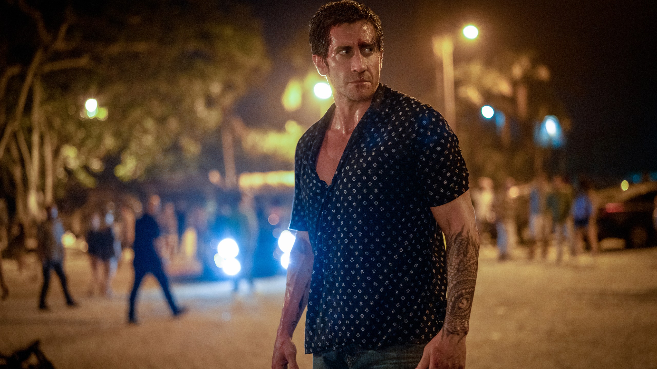 Image may contain Jake Gyllenhaal Lighting Person Walking Adult Photography Face Head Portrait City and Blouse