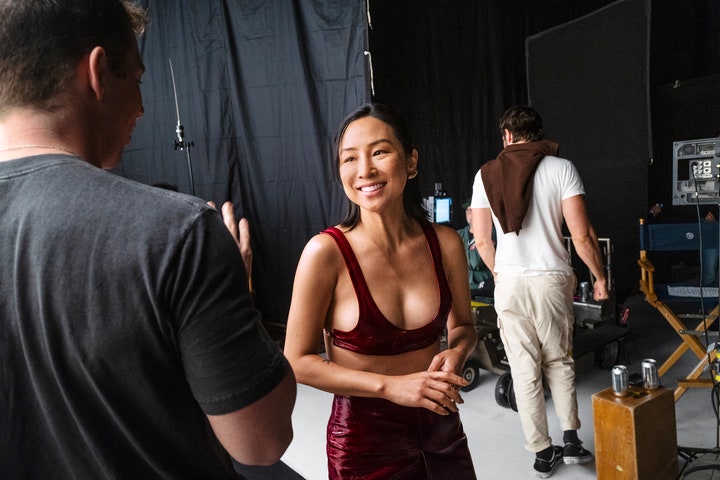 Greta Lee in a Gucci top and skirt Chanel Fine Jewelry cuff and Belperron ear clips behind the scenes at the 2024 Vanity...