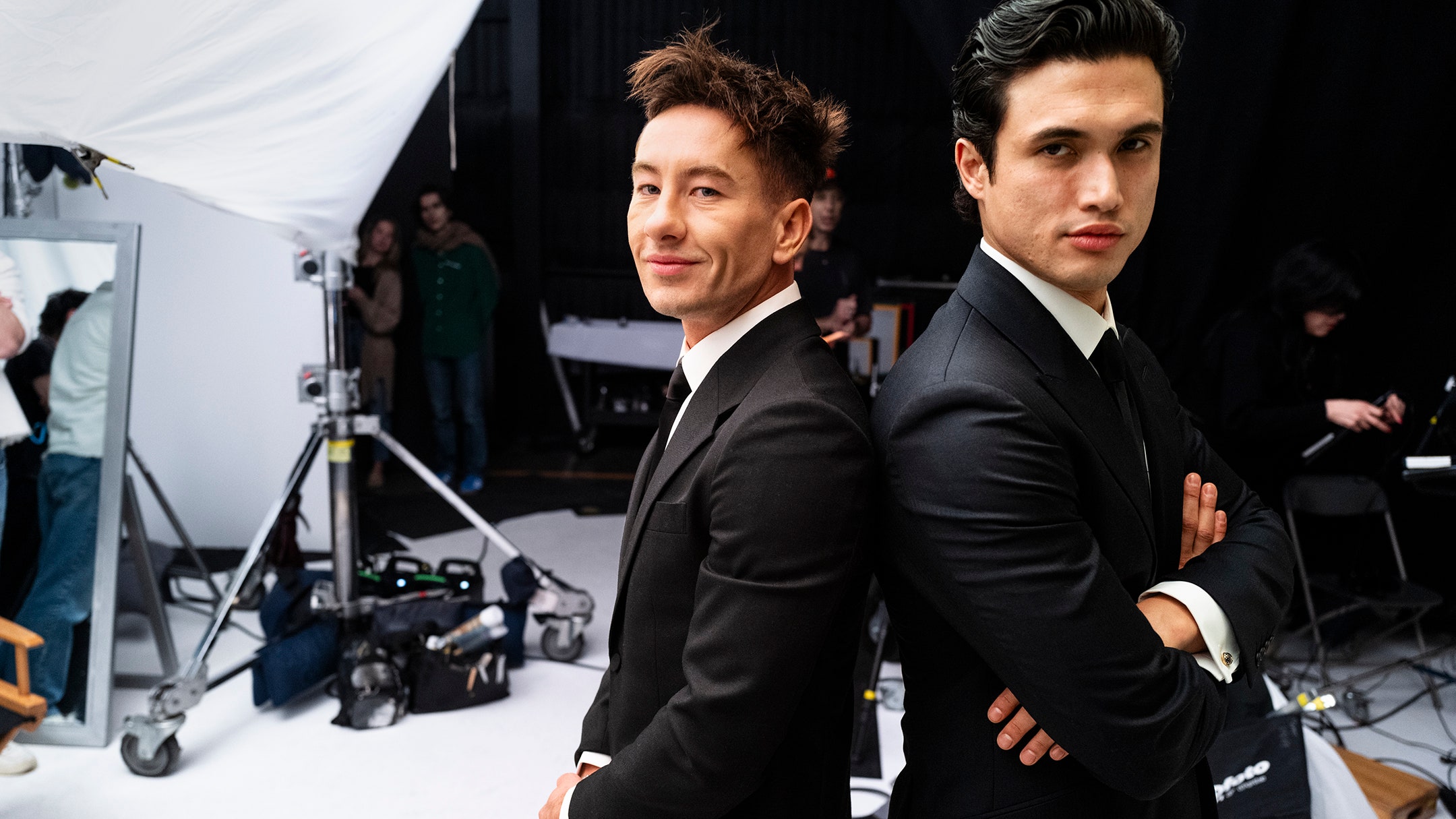 Barry Keoghan and Charles Melton pose back to back on the set of the 2024 Hollywood Portfolio shoot. Barry Keoghans suit...