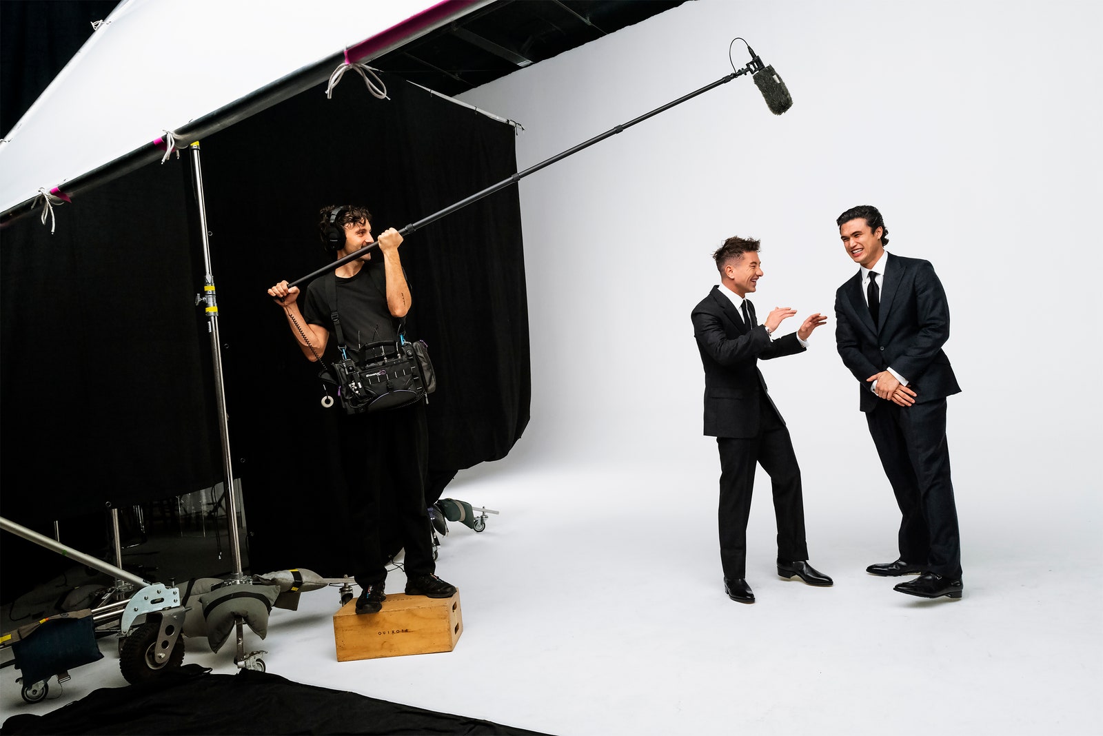 Barry Keoghan and Charles Melton laugh together on the set of Vanity Fairs 2024 Hollywood Portfolio shoot. Barry...
